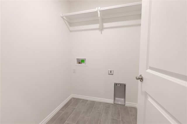 washroom featuring hookup for a washing machine, baseboards, hookup for an electric dryer, wood finish floors, and laundry area