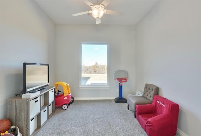 rec room with ceiling fan and light carpet