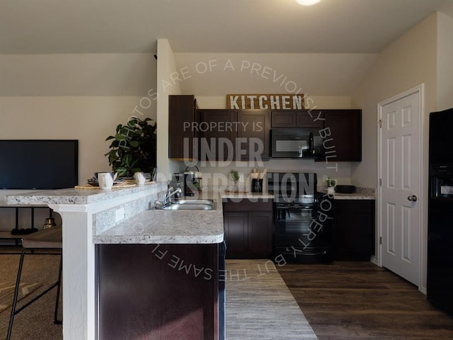 kitchen with a kitchen breakfast bar, dark brown cabinetry, black appliances, dark hardwood / wood-style floors, and lofted ceiling