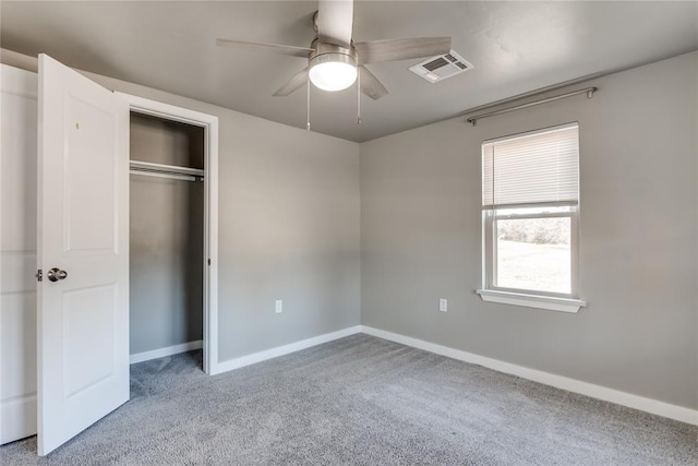 unfurnished bedroom with ceiling fan, light carpet, and a closet