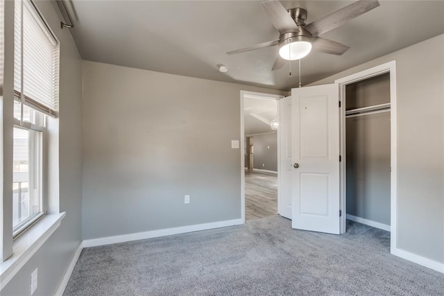 unfurnished bedroom featuring light carpet, a closet, and ceiling fan