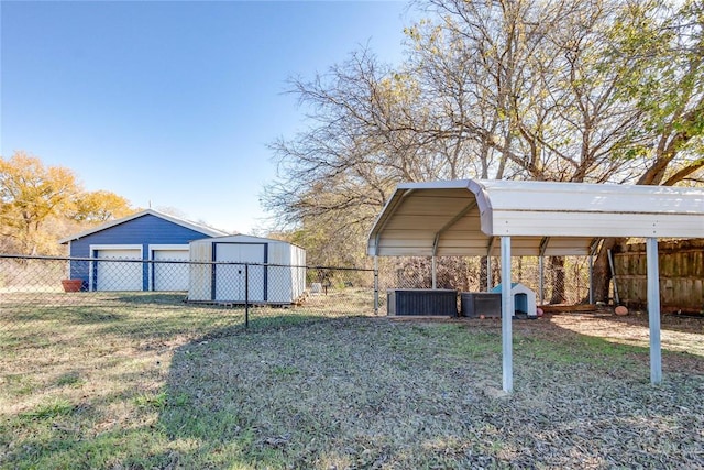 view of yard featuring a carport and a storage unit