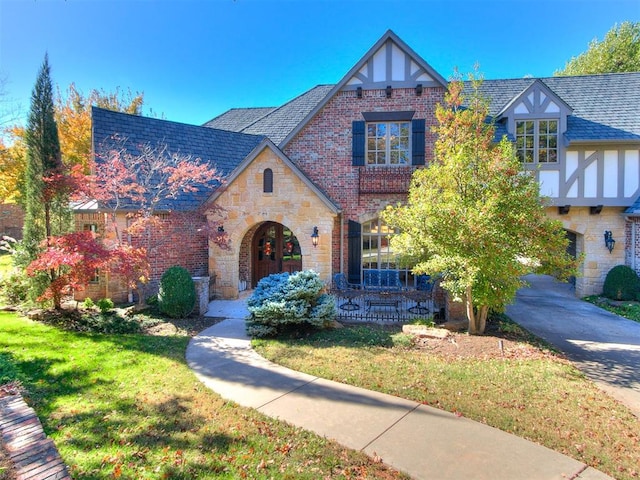 english style home with a front yard