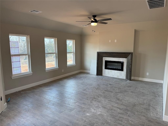 unfurnished living room featuring vaulted ceiling and ceiling fan