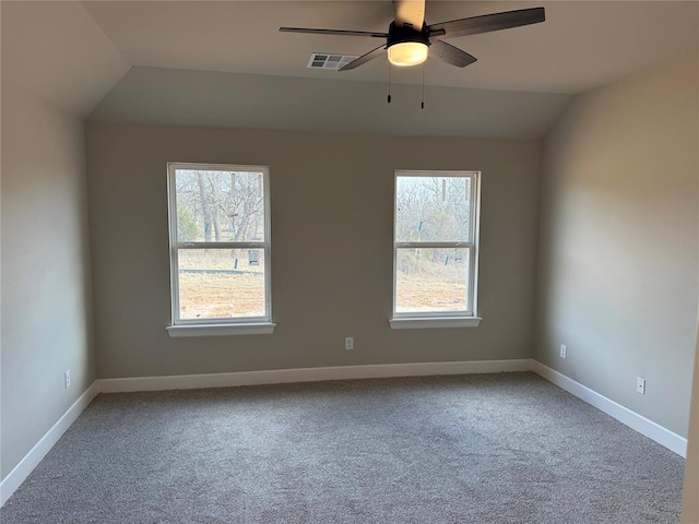 unfurnished room featuring plenty of natural light, carpet floors, and lofted ceiling