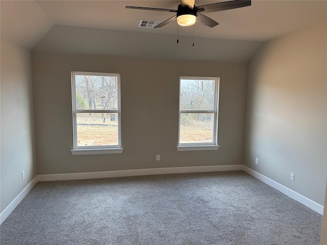 carpeted spare room with ceiling fan and lofted ceiling