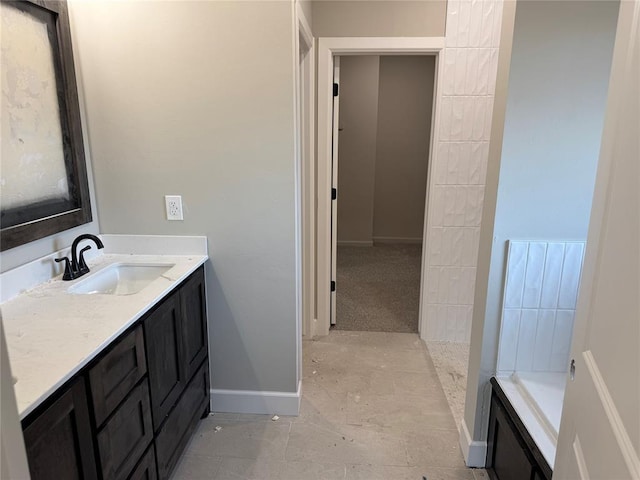 bathroom with vanity and a tub to relax in