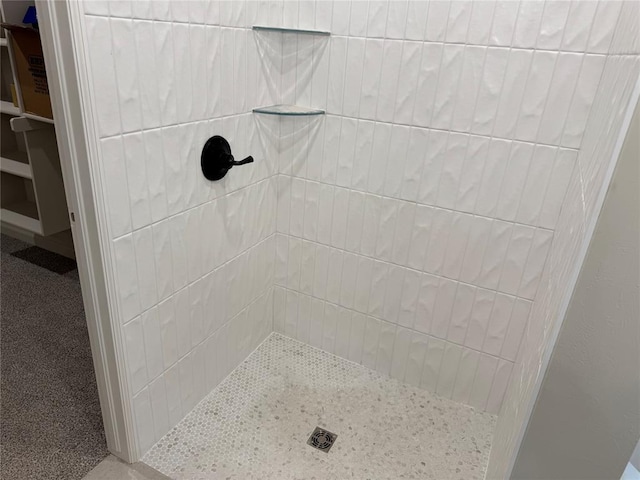 bathroom with a tile shower