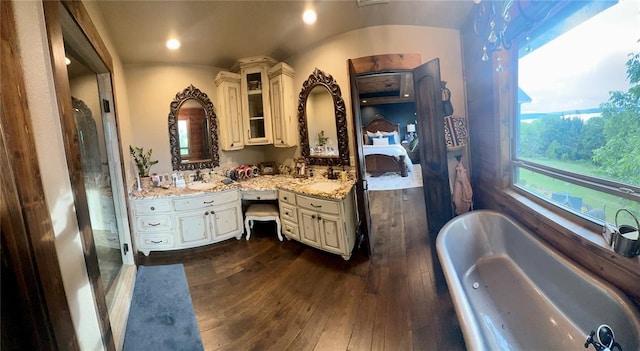 bathroom featuring wood-type flooring, vanity, and shower with separate bathtub