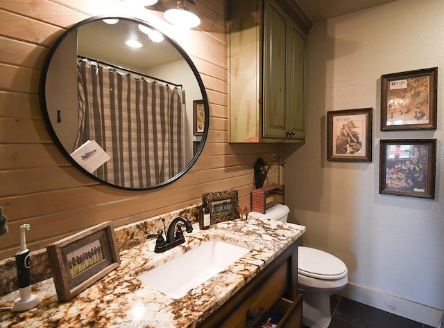 bathroom with a shower with curtain, tile patterned flooring, vanity, and toilet