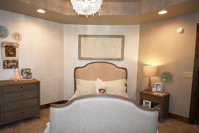 carpeted bedroom featuring a notable chandelier