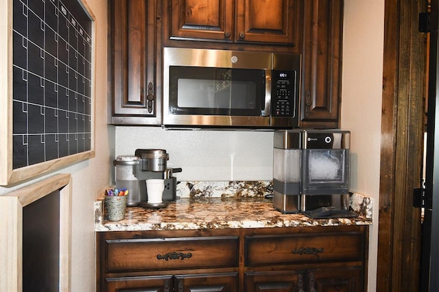 kitchen with dark brown cabinets and light stone counters