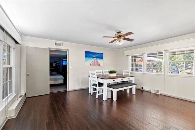 dining space with ceiling fan, dark hardwood / wood-style floors, and ornamental molding