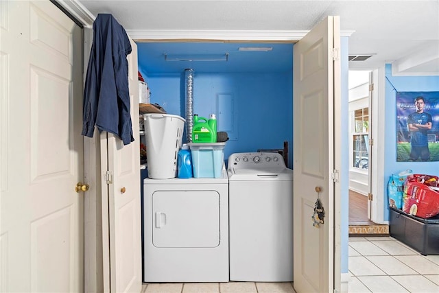 washroom featuring independent washer and dryer and light tile patterned flooring