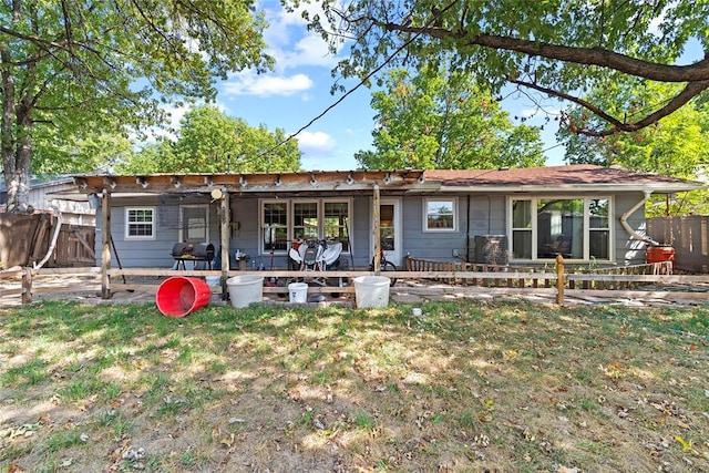 rear view of property with a yard