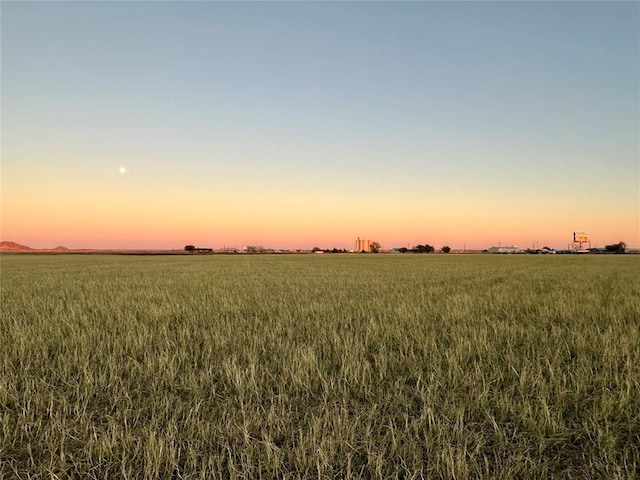 nature at dusk featuring a rural view