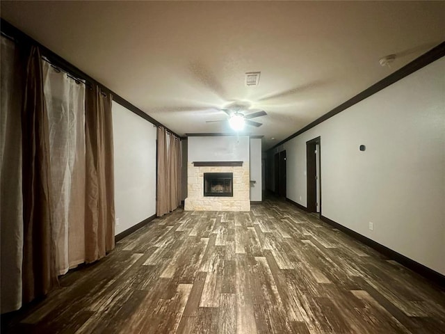 unfurnished living room with a fireplace, wood-type flooring, ceiling fan, and ornamental molding