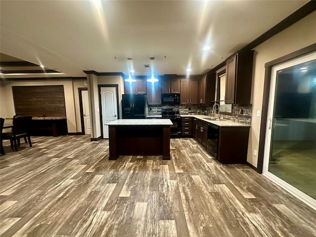 kitchen with dark hardwood / wood-style flooring, tasteful backsplash, dark brown cabinets, black appliances, and a center island