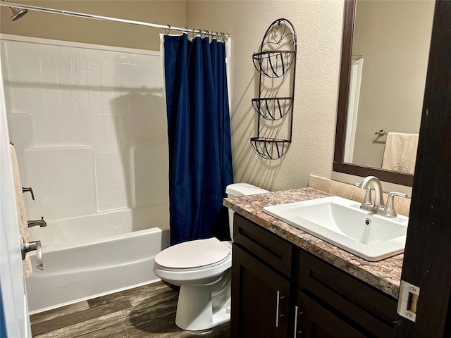 full bathroom featuring hardwood / wood-style floors, vanity, toilet, and shower / tub combo with curtain