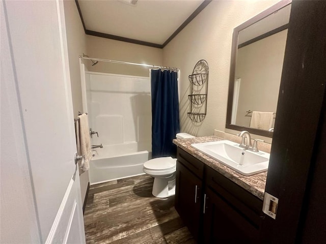 full bathroom featuring hardwood / wood-style floors, toilet, vanity, shower / tub combo, and ornamental molding