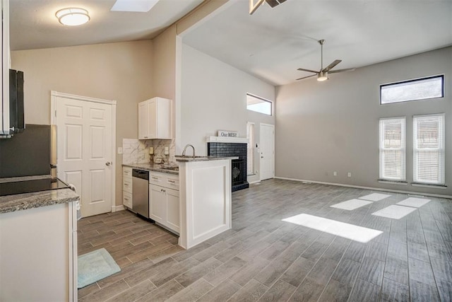 kitchen with white cabinetry, plenty of natural light, and high vaulted ceiling