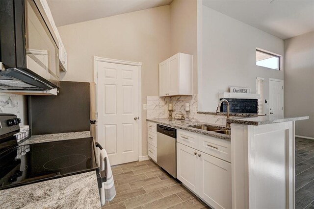 kitchen featuring black appliances, kitchen peninsula, light wood-type flooring, light stone counters, and white cabinetry