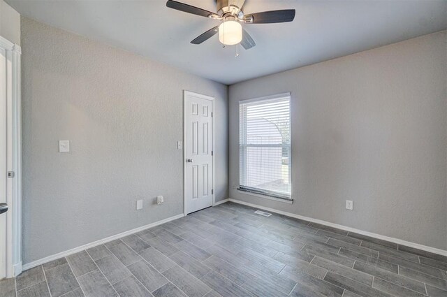 empty room featuring ceiling fan and hardwood / wood-style flooring