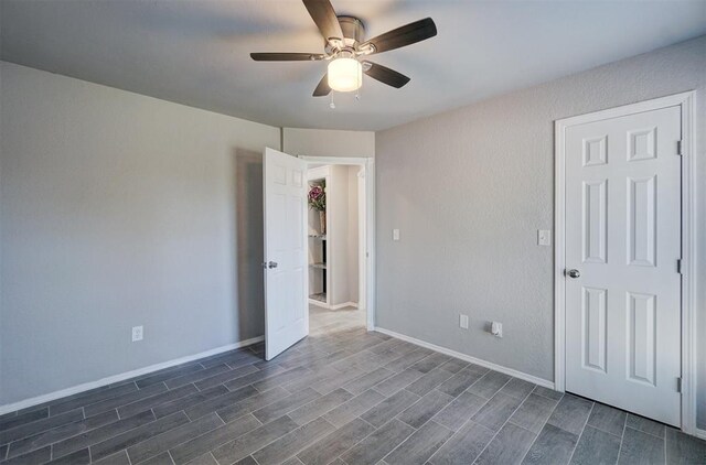 spare room with dark hardwood / wood-style flooring and ceiling fan