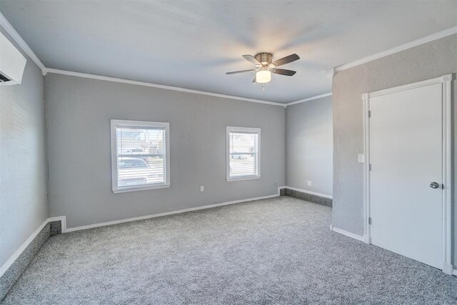 spare room with ceiling fan, light colored carpet, and crown molding