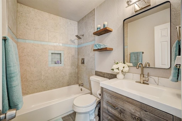 full bathroom featuring vanity, toilet, and tiled shower / bath