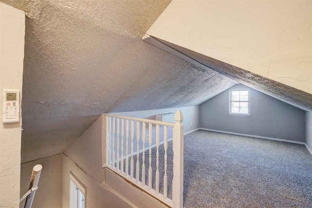 bonus room with carpet and lofted ceiling