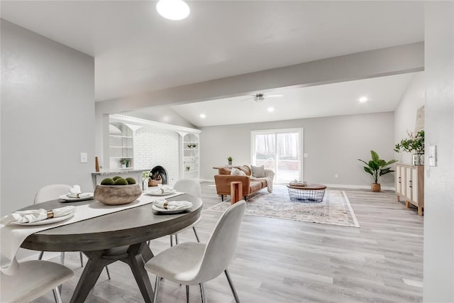 dining room featuring lofted ceiling with beams, ceiling fan, light hardwood / wood-style floors, and built in shelves