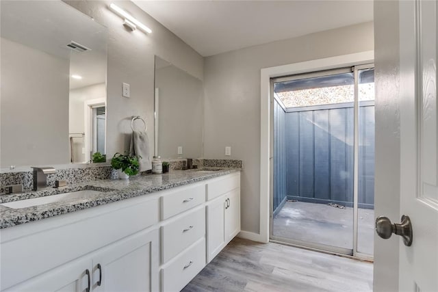 bathroom with hardwood / wood-style floors and vanity