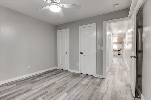 unfurnished bedroom featuring ceiling fan and light hardwood / wood-style flooring