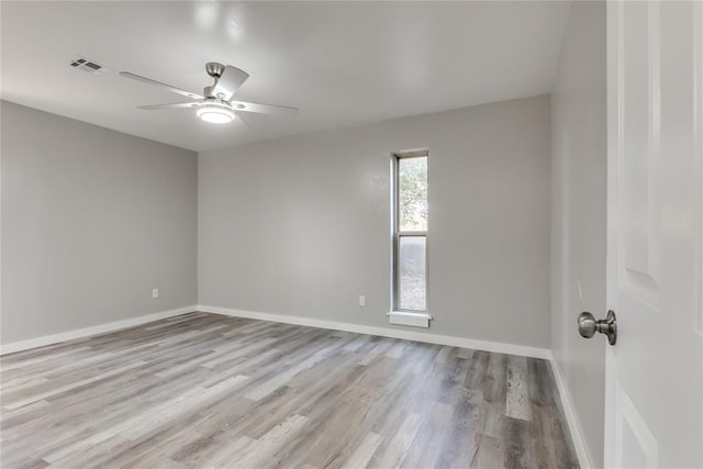 empty room with ceiling fan and light hardwood / wood-style floors