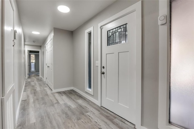 corridor with light hardwood / wood-style floors