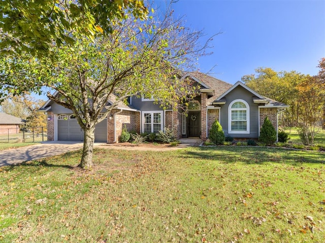 view of front of home with a front yard and a garage