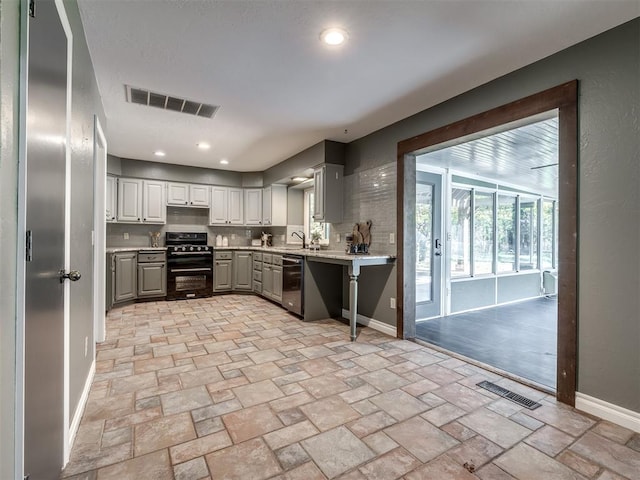 kitchen with dishwasher, gray cabinets, black gas stove, and sink