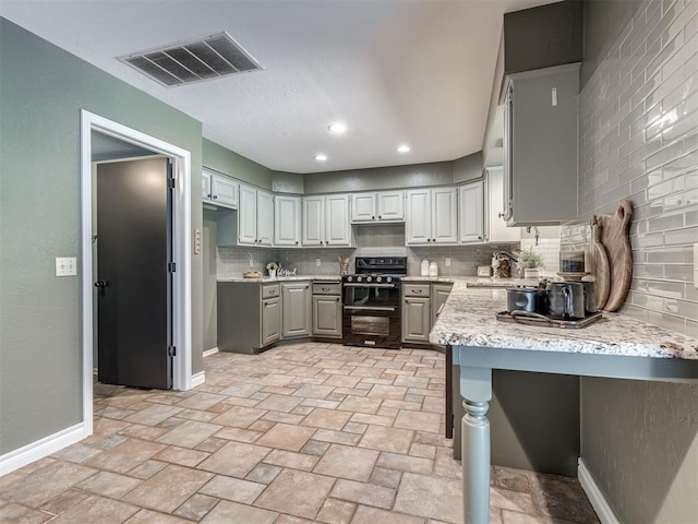 kitchen featuring tasteful backsplash, gray cabinets, sink, and black electric range oven