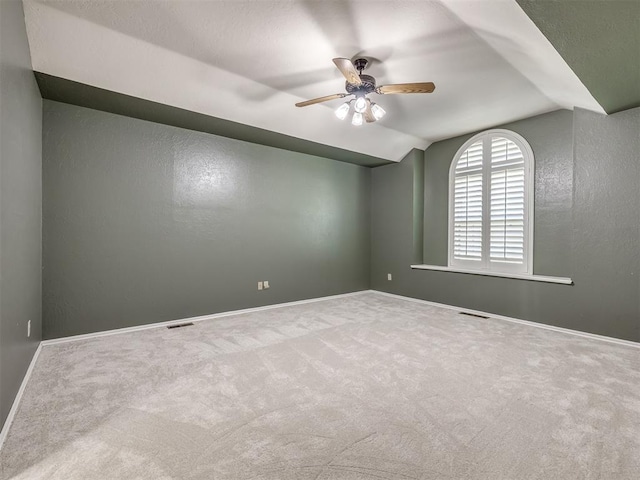 unfurnished room featuring carpet flooring, ceiling fan, and vaulted ceiling