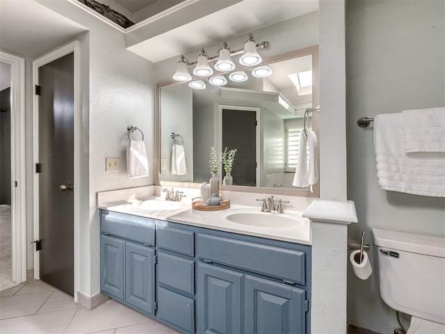 bathroom with tile patterned floors, vanity, and toilet