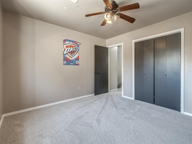 unfurnished bedroom with carpet, a closet, and ceiling fan