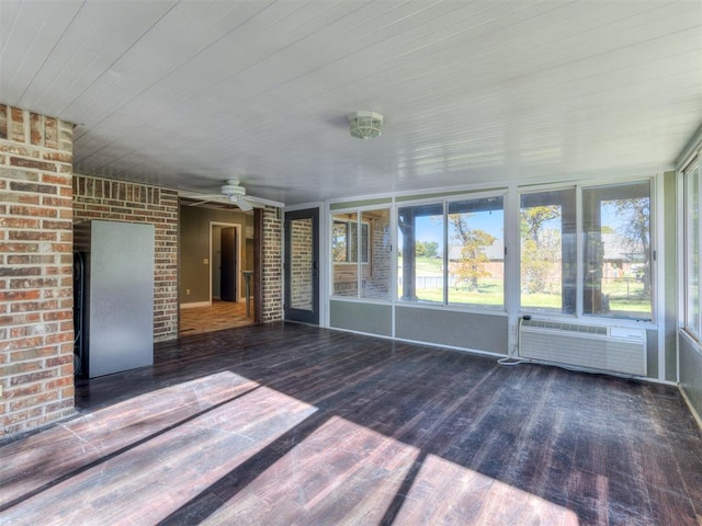 unfurnished sunroom with ceiling fan