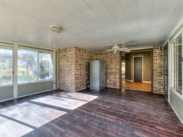 unfurnished sunroom featuring ceiling fan and wooden ceiling