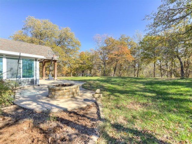 view of yard featuring a patio and a fire pit