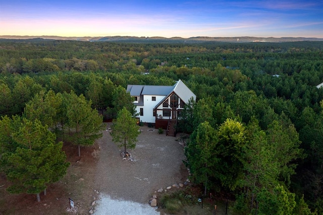 aerial view at dusk featuring a mountain view