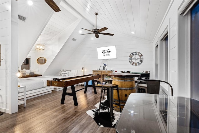 dining area with dark hardwood / wood-style flooring, wood ceiling, ceiling fan, wooden walls, and lofted ceiling