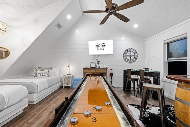 recreation room with ceiling fan, wooden ceiling, dark hardwood / wood-style flooring, vaulted ceiling, and wooden walls