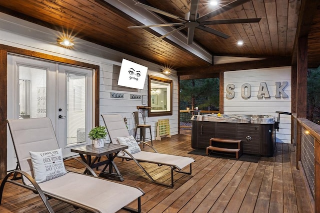 wooden deck with ceiling fan and a hot tub