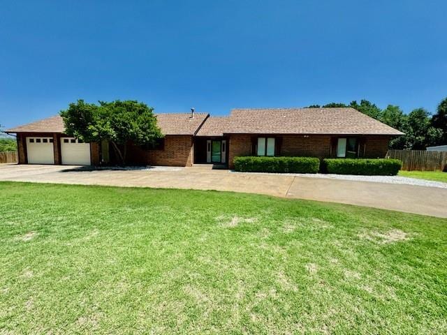 ranch-style house with a front yard and a garage